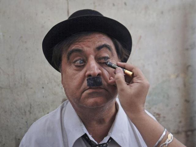 Ashok Aswani has his make-up applied as he gets dressed up for Charlie Chaplin's birthday celebrations in Adipur in Gujarat. (Reuters/Danish Siddiqui)