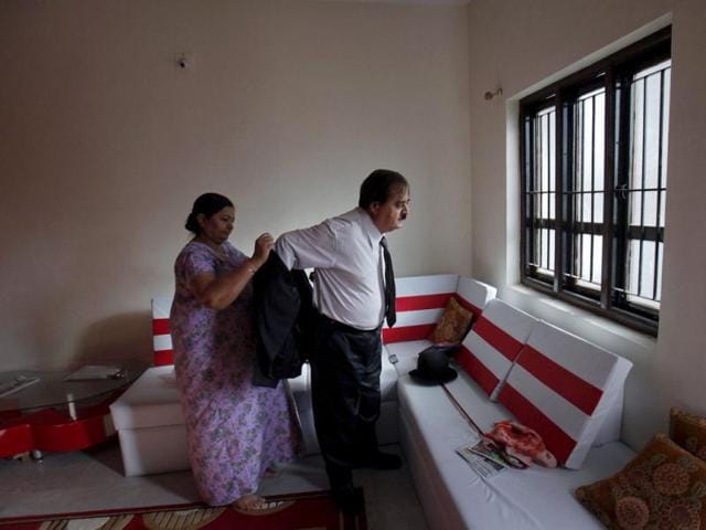 Ashok Aswani is helped by his wife as he gets dressed up as Charlie Chaplin in his house in Adipur in Gujarat. (Reuters/Danish Siddiqui)