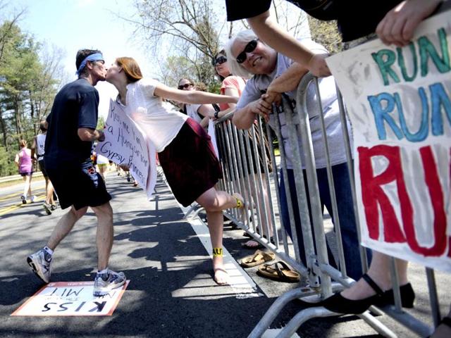 Wellesley College Sophomore Mayrah Udvardi, of Canberra, Australia, gives a runner a kiss along the route of the 116th Boston Marathon in Wellesley, Massachusetts. (Reuters/Gretchen Ertl)