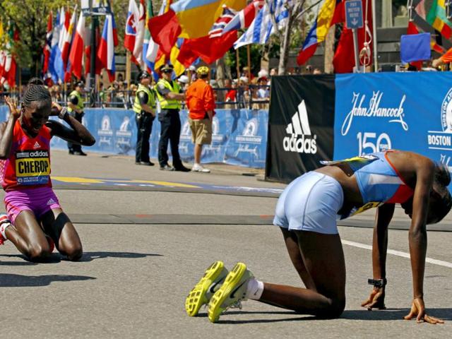 Winner of the women's division of the Boston Marathon Sharon Cherop of Kenya and second place finisher Jemima Jelagat Sumgong of Kenya react after crossing the finish line of the 116th Boston Marathon in Boston. (Reuters/Brian Snyder)