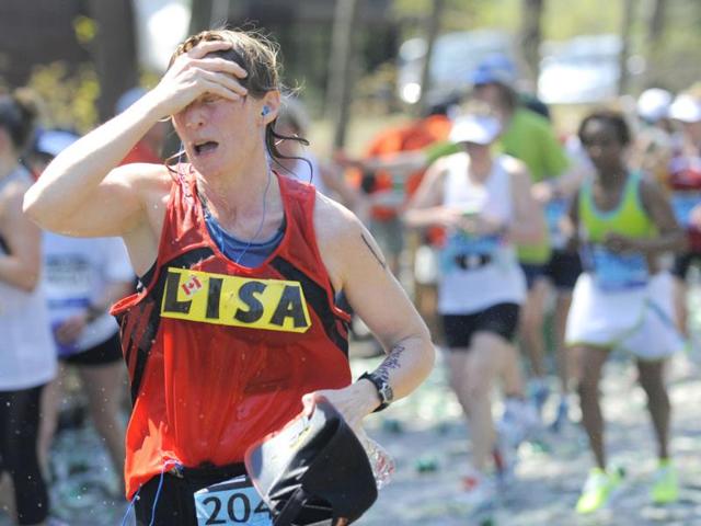 A runner feels the heat along the route of the 116th Boston Marathon in Wellesley, Massachusetts. (Reuters/Gretchen Ertl)