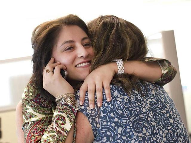 Patriot-News reporter Sara Ganim calls her sister while hugging Patriot-News reporter Jan Murphy after winning the 2012 Pulitzer Prize for Local Reporting , at the paper's offices in Harrisburg. Ganim broke the news of the grand jury investigation into allegations against former Penn State assistant football coach Jerry Sandusky, and reported his indictment on charges of molesting several boys involved in a charity he ran. AP Photo/The Patriot-News, Christine Baker