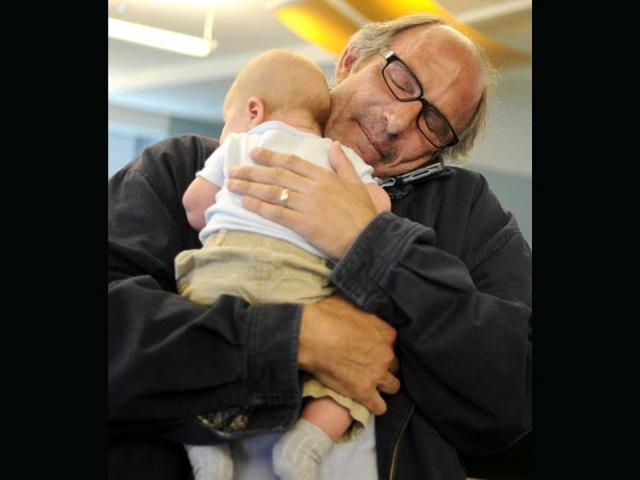 Denver Post staff photographer Craig F Walker hugs his son, Quinn, as he tells his mother he won his second Pulitzer Prize for Feature Photography, for his story on veteran Scott Ostrom's battle with PTSD. AP/The Denver Post, Aaron Ontiveroz