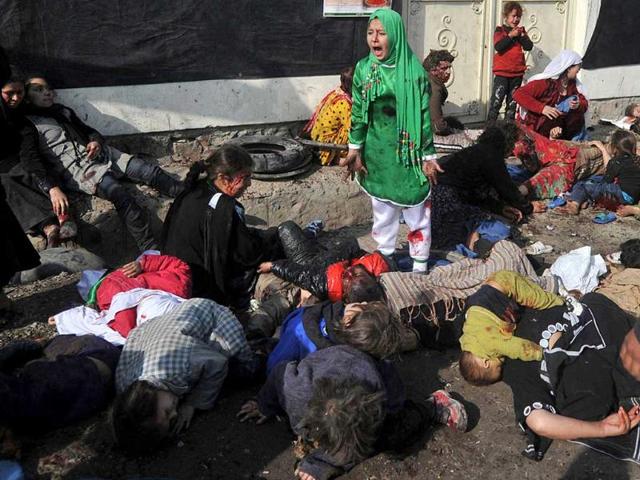 This photo by Massoud Hossaini was awarded the 2012 Pulitzer Prize for Breaking News Photography, announced in New York. It depicts Tarana Akbari, 12, screaming in fear, moments after a suicide bomber detonated a bomb in a crowd at the Abul Fazel Shrine in Kabul on Dec. 6, 2011. AP/AFP via the Pulitzer Prize Board, Massoud Hossaini