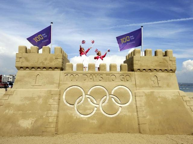 Children stand on a giant sand castle built on Weymouth beach to mark 100 days to go to the London 2012 Olympic Games, in Weymouth, southern England. Weymouth and Portland will host the Olympic and Paralympic sailing at the London 2012 Olympic and Paralympic Games. The photograph was taken to mark the 100 days milestone which is on. Reuters/Locog//Handout