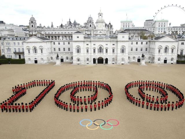 In this photo issued by London 2012 London Organizing Committee of the Olympic and Paralympic Games (LOCOG), 260 Guardsmen from the Grenadier, Coldstream, Scots and Welsh Guards mark 100 days before the London 2012 Olympic Games at Horse Guards Parade in central London. The opening ceremony will take place on July 27, 2012. (AP Photo/LOCOG)