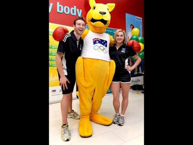 Australia's Beijing 2008 Olympic diving gold medallist Matt Mitcham (L) and silver medallist Melissa Wu (R) pose with the Boxing Kangaroo as the Australian Olympic Committee (AOC) in Sydney . AFP Photo / William West