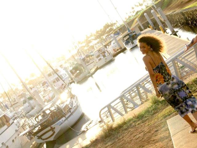 Rihanna looks pretty in a printed beach dress.