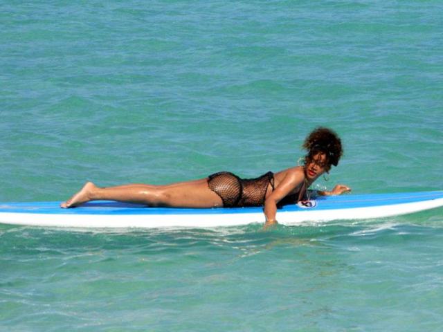 The What's My Name singer floats in the sea.