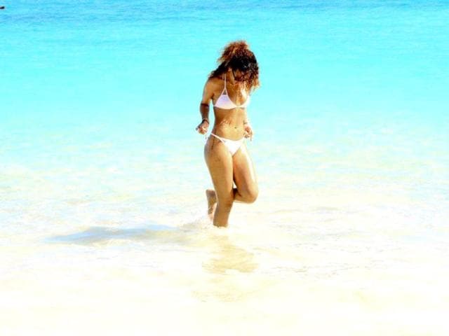 Rihanna enjoys in the sea, flaunting her toned beach body.