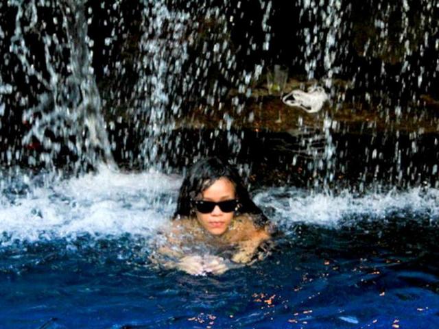Rihanna swims under a waterfall. Have you ever done that?