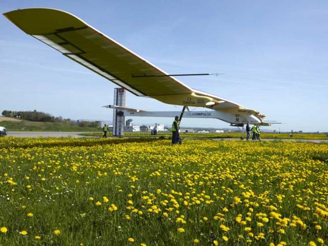 Staff push the Solar Impulse's solar-powered HB-SIA prototype airplane after a test flight at Payerne airport. Reuters/Denis Balibouse