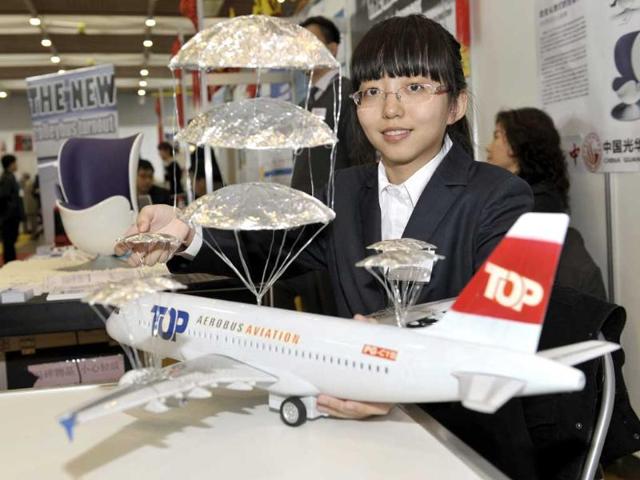 Yu Gao of China presents her invention, an emergency landing system of multi-layer parachutes for airplanes. AP/Martial Trezzini