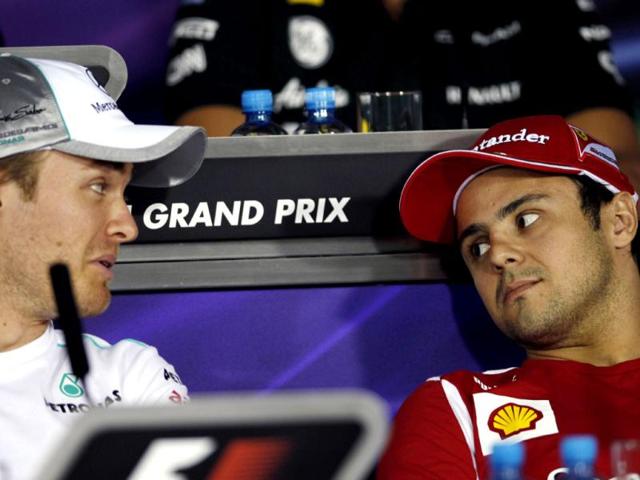 Mercedes Grand Prix driver Nico Rosberg of Germany, left, talks to Ferrari driver Felipe Massa of Brazil during a news conference ahead the Bahrain Formula One Grand Prix at the Formula One Bahrain International Circuit in Sakhir, Bahrain.The Bahrain GP was canceled last year due to anti-government protests. AP/Luca Bruno