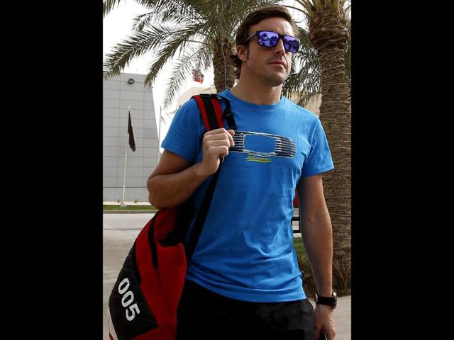 Ferrari driver Fernando Alonso of Spain arrives in the paddock ahead the Bahrain Formula One Grand Prix at the Formula One Bahrain International Circuit in Sakhir, Bahrain. The Bahrain GP was canceled last year due to anti-government protests. AP/Luca Bruno