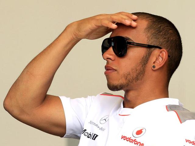 McLaren Mercedes driver Lewis Hamilton of Britain gestures in the paddock ahead the Bahrain Formula One Grand Prix at the Formula One Bahrain International Circuit in Sakhir, Bahrain. The Bahrain GP was canceled last year due to anti-government protests. AP/Luca Bruno