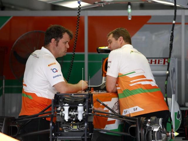 Force India technicians talk to each others at pits at the Bahrain International Circuit in Sakhir, Bahrain. The Bahrain GP was canceled last year due to anti-government protests. AP/Luca Bruno