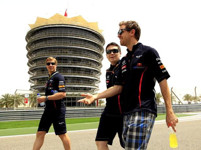 Red Bull driver Sebastian Vettel of Germany, right, walks with team technicians at the Formula One Bahrain International Circuit in Sakhir, Bahrain. The Bahrain Grand Prix was canceled last year due to anti-government protests. AP/Luca Bruno