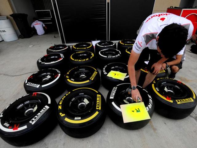 A crew member labels tires in the paddock at the Bahrain International Circuit in Manama ahead of the Bahrain Formula One Grand Prix. AFP/Dimitar Dilkoff