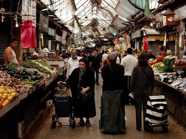 Israelis pause during a two-minute siren in memory of victims of the Holocaust in the market in Jerusalem. The day is one of the most solemn on Israel's calendar. AP Photo/Bernat Armangue