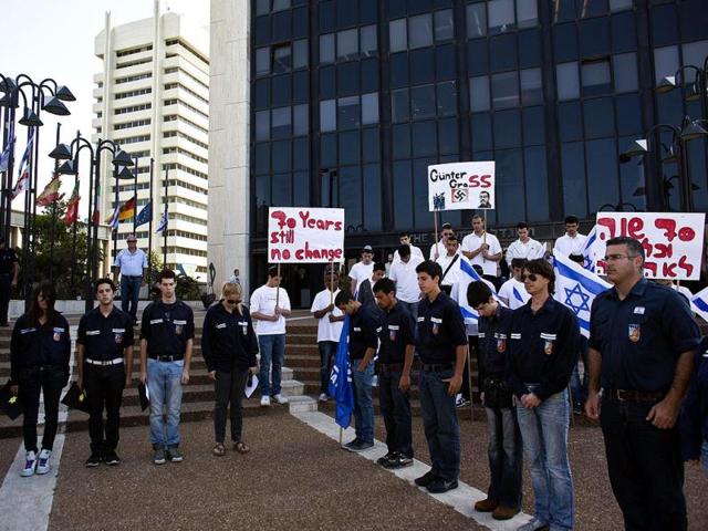 Israelis hold a demonstration outside the German Embassy in Tel Aviv against German author Guenter Grass as they stand still during the sounding of a siren marking Israel's annual day of Holocaust remembrance. Reuters Photo/Nir Elias
