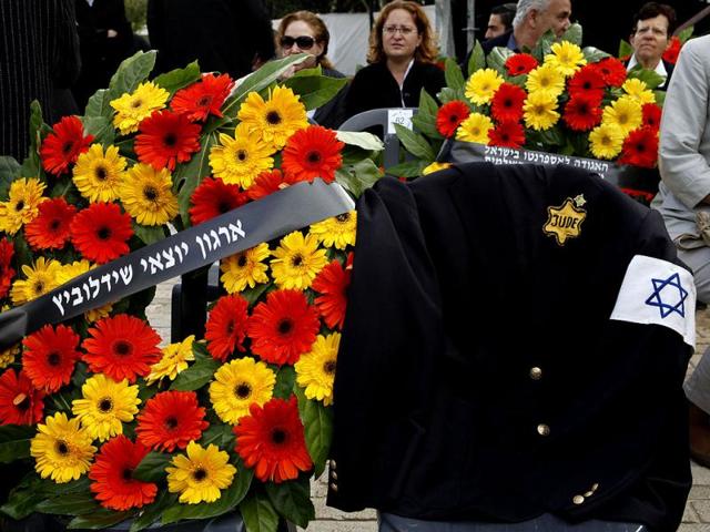 A jacket belonging to Polish-born Israeli Holocaust survivor Mordechai Fuchs, who passed away three months ago, with a Star of David and "Jude", written on it is placed on a chair during the annual Holocaust Memorial Day ceremony at the Yad Vashem Holocaust Museum in Jerusalem. AFP Photo/Gali Tibbon