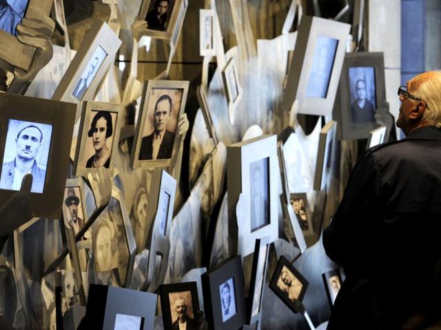 An elderly man looks at the portraits of Macedonian Jews who were killed in the Nazi extermination camp Treblinka, displayed in the Holocaust Memorial center of the Jews of Macedonia in the country's capital Skopje. AP Photo/Boris Grdanoski