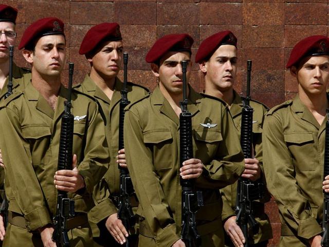 Israeli soldiers observe two minutes of silence as sirens wail across Israel to mark Holocaust Remembrance Dayduring the annual ceremony at the Yad Vashem memorial in Jerusalem. AFP Photo/Pool/Gali Tibbon