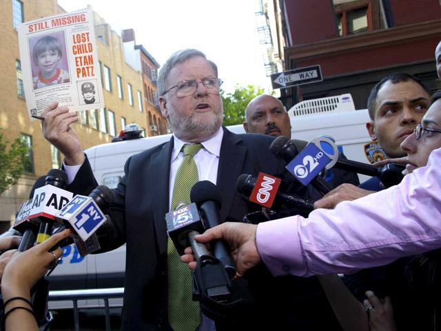 New York police spokesman Paul Browne holds up an original Etan Patz missing person poster while speaking to reporters near an apartment building in Soho. Police officers and FBI agents began tearing apart a New York City basement Thursday as part of a decades-old investigation into the disappearance of 6-year-old Etan Patz, who disappeared May 25, 1979, after leaving his family's Manhattan apartment for a short walk to catch a school bus. (AP Photo/Mary Altaffer)