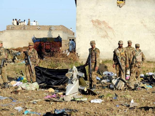 Pakistani soldiers seach the site in Hussain Abad after a Bhoja Air Boeing 737 plane crashed on the outskirts of Islamabad. AFP Photo/Aamir Qureshi