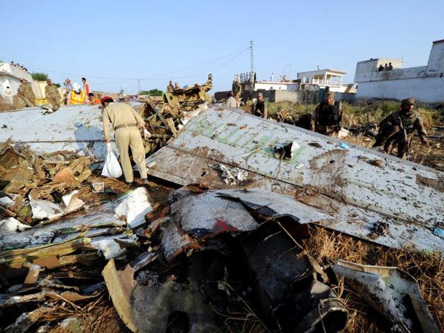 Pakistani soldiers search through debris in Hussain Abad after a Bhoja Air Boeing 737 plane crashed on the outskirts of Islamabad. AFP Photo/Aamir Qureshi
