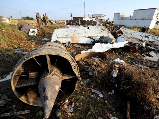 Pakistani soldiers stand next to the wreckage in Hussain Abad after a Bhoja Air Boeing 737 plane crashed on the outskirts of Islamabad. AFP Photo/Aamir Qureshi