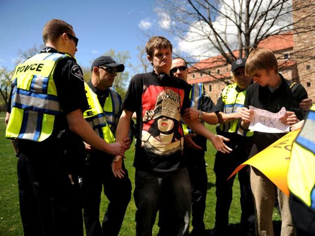Colorado University senior Gabriel Kuettel is arrested for trespassing on the Norlin Quad which was closed to crackdown on pro-marijuana protesters at the school in Boulder, Colo. A block-long line of protesters marched onto the University of Colorado, testing the school's determination to push the annual marijuana celebration off campus. (AP Photo/The Denver Post, Joe Amon)