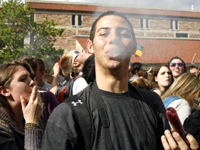 A man exhales after smoking marijuana in a pipe at a pro-marijuana rally at the University of Colorado in Boulder, Colorado. The University of Colorado clamped down on a huge annual marijuana fest on Friday by restricting access to the school and a field where the "smoke-in" is traditionally held, and three protesters were arrested ahead of the event. The event was held on April 20, a date and time corresponding with a numerical 4/20 code widely known within the cannabis subculture as a symbol for all things marijuana. REUTERS/Rick Wilking