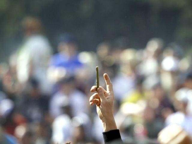 A supporter of legalized marijuana holds up a small blunt as thousands gathered to celebrate the state's medicinal marijuana laws and collectively light up in Civic Center Park April 20, 2012 in Denver, Colorado on Colorado goes to the polls November 6 to vote on a controversial ballot initiative that would permit possession of up to an ounce of marijuana for those 21 and older. Marc Piscotty/Getty Images/AFP