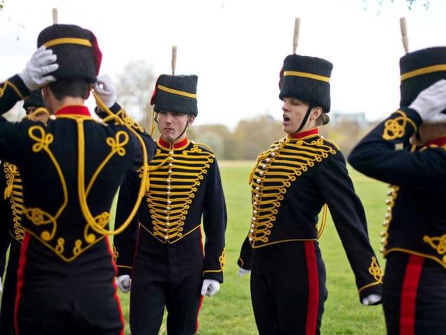 Members of the gun team from the Kings Troop of the Royal artillery await the firing of a 41 gun salute in London's Hyde Park in honour of her Royal Highness Queen Elizabeth II's 86th birthday in central London. AFP Photo / Leon Neal