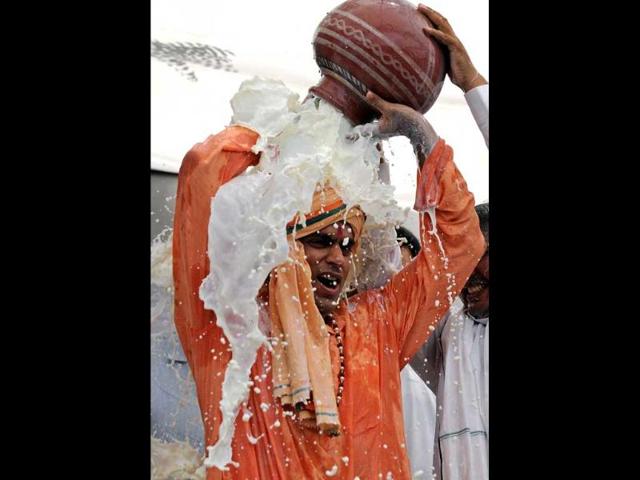 Milkmen from Delhi and Western Uttar Pradesh pour milk during a protest in New Delhi. (AFP photo/Prakash Singh)
