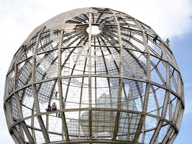 Workers replace broken LED lights on a huge bronze globe in front of a mall in Manila. At night, the structure will turn into an LED globe, a video display with resolution and full graphics made possible by the LED's 26,300 pieces of point lights. Activists across the globe are celebrating Earth Day on April 22 with events aimed at bringing awareness of environmental concerns. AFP PHOTO / NOEL CELIS