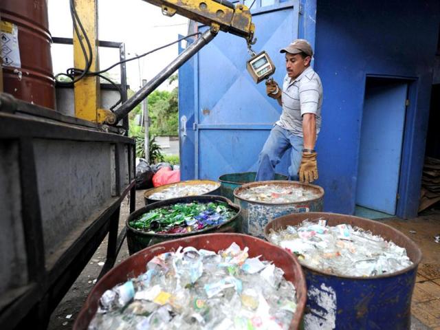 A man works with tanks containing glass waste at a classification plant in Juan Vinas, on the outskirts of San Jose, Costa Rica. Activists across the globe will celebrate Earth Day on April 22 with events aimed at bringing awareness of environmental concerns. AFP PHOTO/Rodrigo ARANGUA