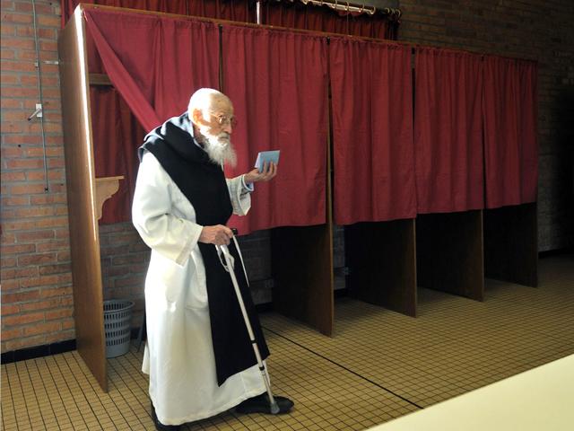 The older Monks of Mont des Cats' abbey Aimable Filipo 98 years old, leaves a polling booth before to cast his ballot in Godewaersvelde, northern France on during the first round of the French presidential election. AFP/Philippe Huguen