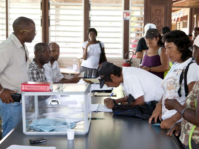 A man signs the vote register after voting at a polling station in Maripasoula, French Guiana, for the first-round poll of French 2012 presidential election. AFP/Jody Amiet