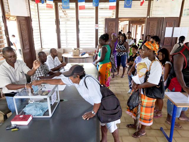 A woman casts her ballot at a polling station in Maripasoula, French Guiana, for the first-round poll of French 2012 presidential election. AFP/Jody Amiet