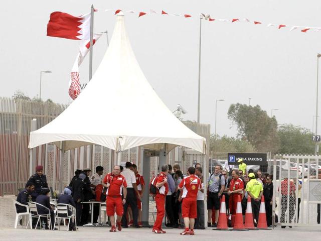 Police and security officers check journalists and Formula One team staff at a gate of the Formula One Bahrain International Circuit in Sakhir, Bahrain. (AP Photo/Hassan Ammar)