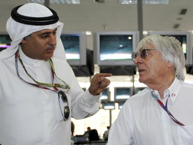 Zayed Alzayani, left, chairman of the Bahrain International Circuit, gestures to Bernie Ecclestone, president and CEO of the Formula One Management, prior to the start of the Bahrain Formula One Grand Prix at the Formula One Bahrain International Circuit in Sakhir, Bahrain. (AP Photo/Luca Bruno)