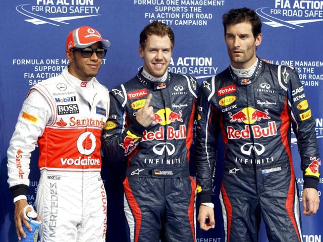 Pole position Red Bull Formula One driver Sebastian Vettel (C) of Germany, second qualified McLaren Formula One driver Lewis Hamilton (L) of Britain and third qualified Red Bull Formula One driver Mark Webber of Australia pose after the qualifying session of the Bahrain F1 Grand Prix at the Sakhir circuit in Manama. REUTERS/Ahmed Jadallah