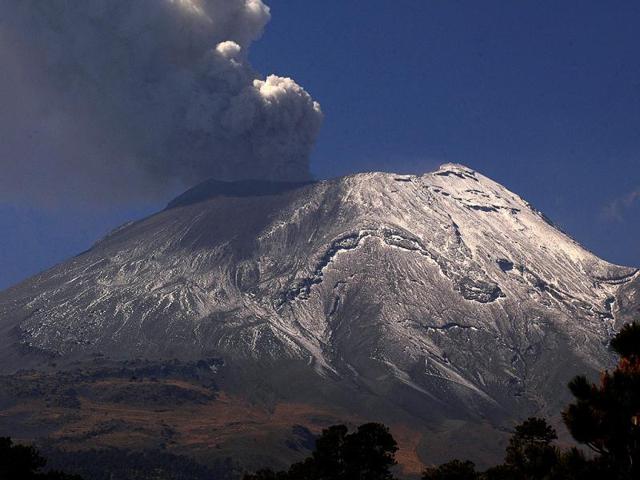 A plume of ash and smoke rises from the Popocatepetl Volcano seen from the outskirts of the town of Santiago Xalizintla, Mexico. AP Photo/Gonzalo Perez