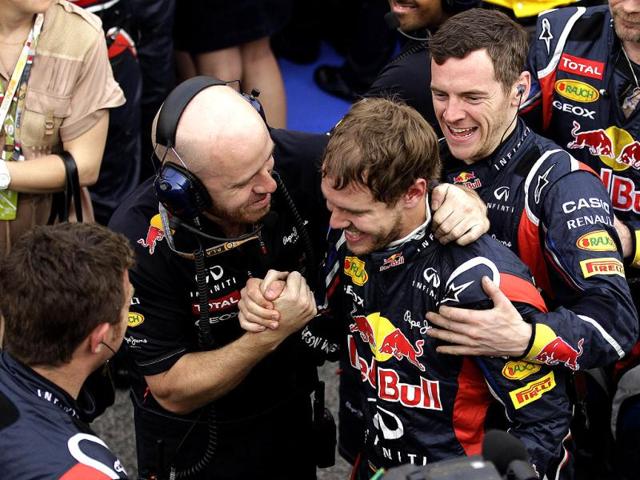 Red Bull driver Sebastian Vettel of Germany, second right, celebrates with his teammates after winning the Bahrain Formula One Grand Prix at the Bahrain International Circuit in Sakhir, Bahrain. (AP Photo/Hassan Ammar