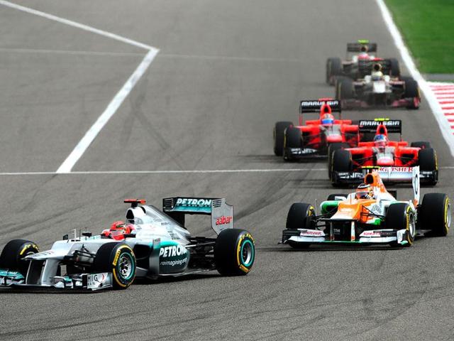 Mercedes' German driver Michael Schumacher, Force India's German driver Nico Hulkenberg, Marussia F1 Team's German driver Timo Glock, Marussia F1 Team French driver Charles Pic, HRT F1 Team's Spanish driver Pedro Martinez de la Rosa and HRT F1 Team's Indian driver Narain Karthikeyan compete at the Bahrain international circuit in Manama during the Gulf kingdom's Formula One Grand Prix. (AFP Photo/Tom Gandolfini)