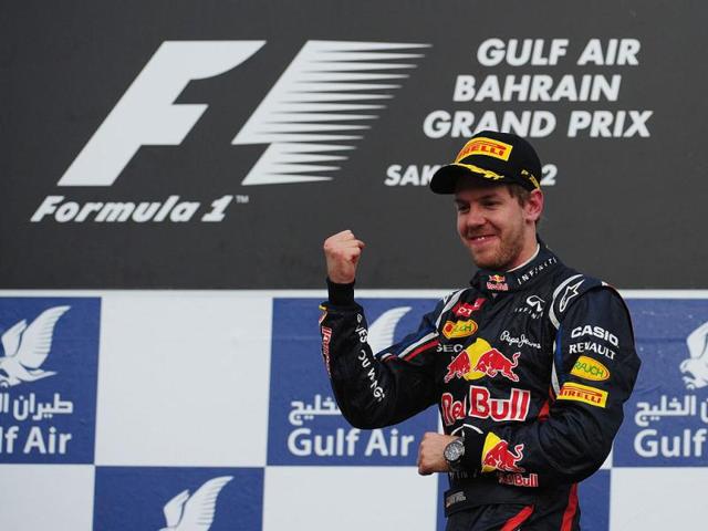Red Bull Racing's German driver Sebastian Vettel celebrates on the podium at the Bahrain International circuit in Manama after the Bahrain Formula One Grand Prix. (AFP Photo/Dimitar Dilkoff)
