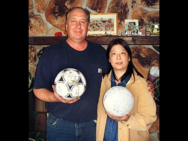 David and Yumi Baxter hold a soccer ball and a volleyball which David found at their house in Alaska. Kyodo News agency says the teenage owner of the soccer ball that apparently floated across the Pacific Ocean after last year's tsunami is surprised and thankful the ball - which had his name written on it - was found in Alaska. AP Photo/The Baxters via Kyodo News